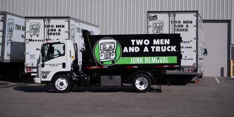 Junk truck next to moving trucks
