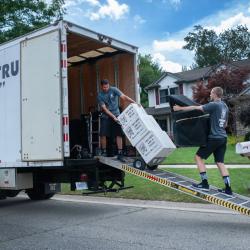 movers loading boxes on a moving truck