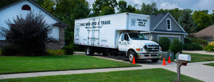 trucked parked in the driveway of a home with safety cones out